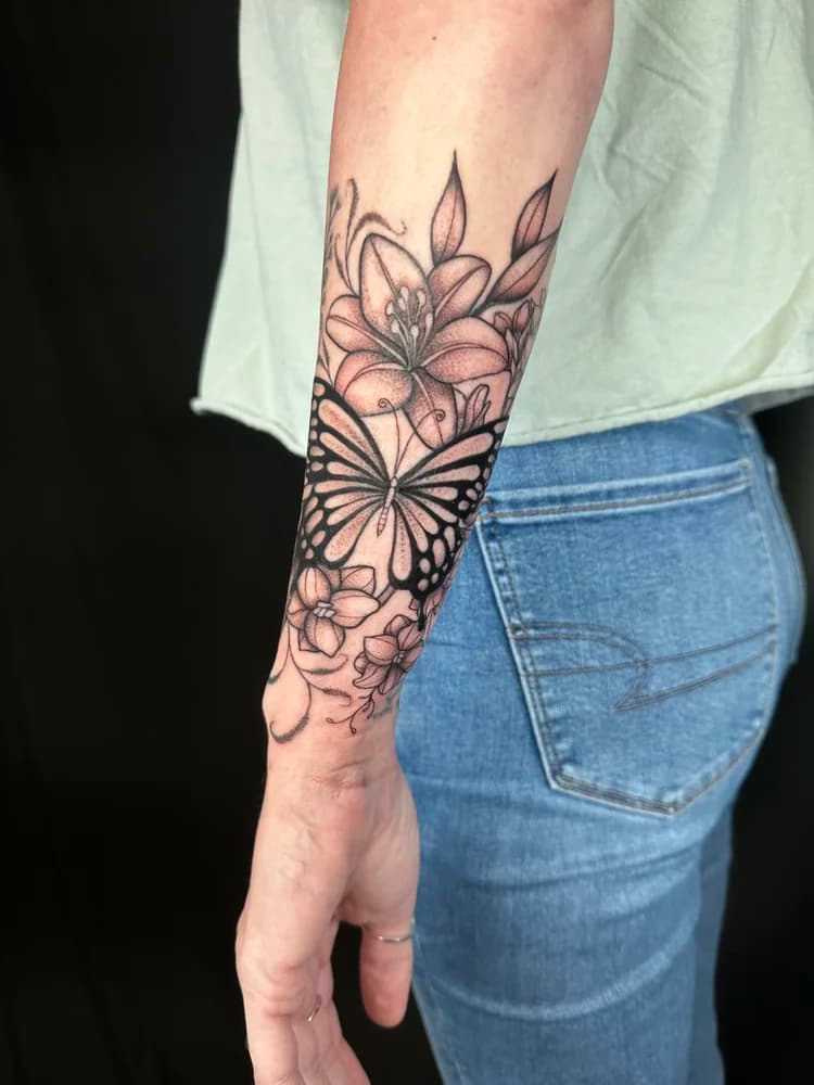 Black and gray floral sleeve tattoo with butterfly and delicate line work