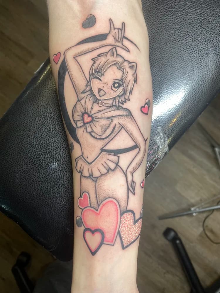 Black and red anime character tattoo on forearm with hearts and decorative elements