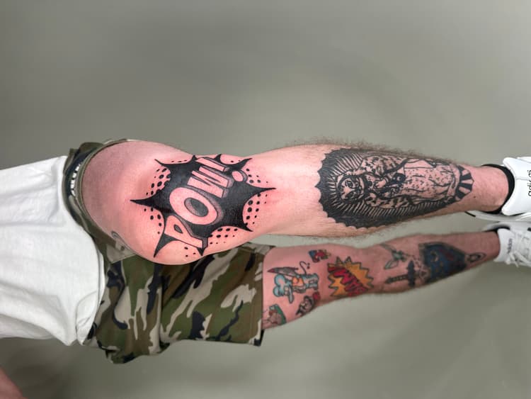 Black full leg tattoo displaying multiple figures with detailed shading work
