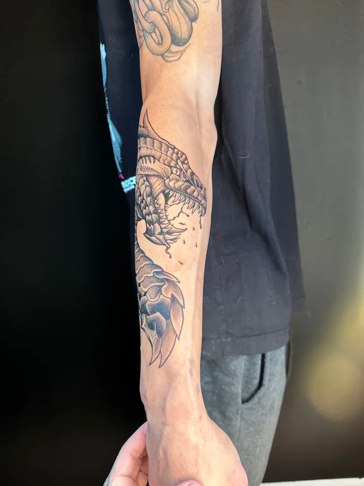 Black ink leg sleeve tattoo with mixed designs including animals and decorative work