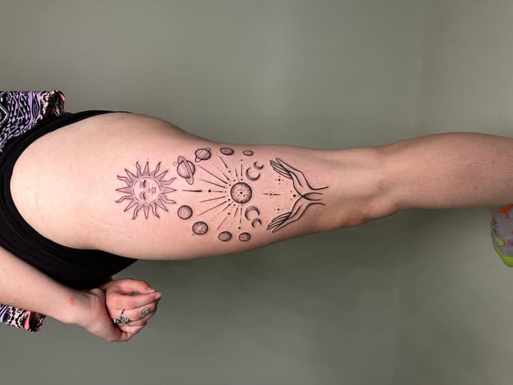 Purple and gray celestial tattoo on arm with sun moon and stars design